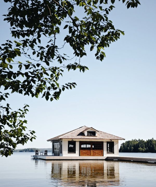 Muskoka Living Projects - Tradewinds Lakehouse designed and built by Muskoka Living. Exterior shot of dock leading to the boathouse.