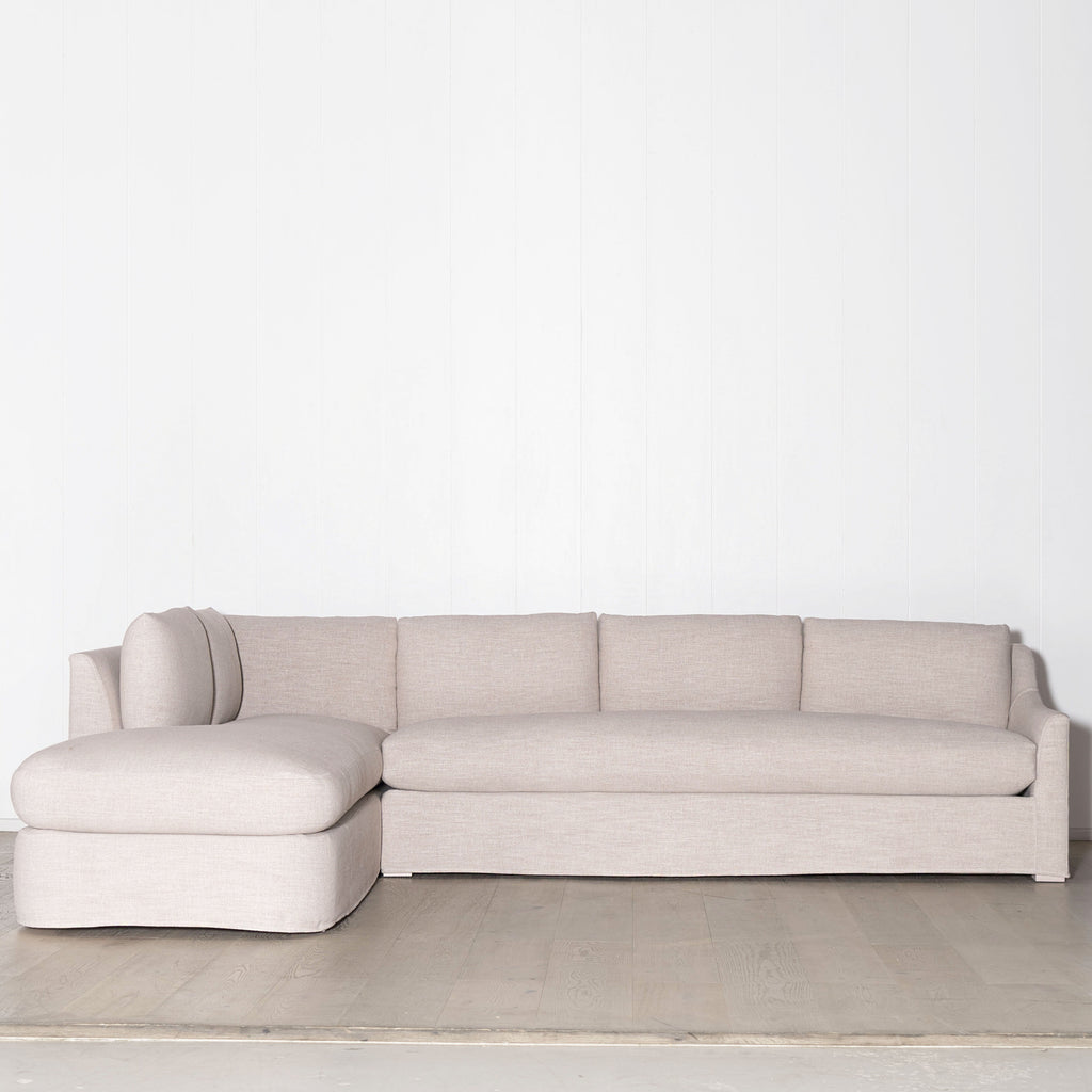Jasper Sectional - Muskoka Living Collection. Made to order at our self-owned and operated workshop in LA. Shown in Slipcovered Belgian Rose. Oak finished Nordic White Super White.