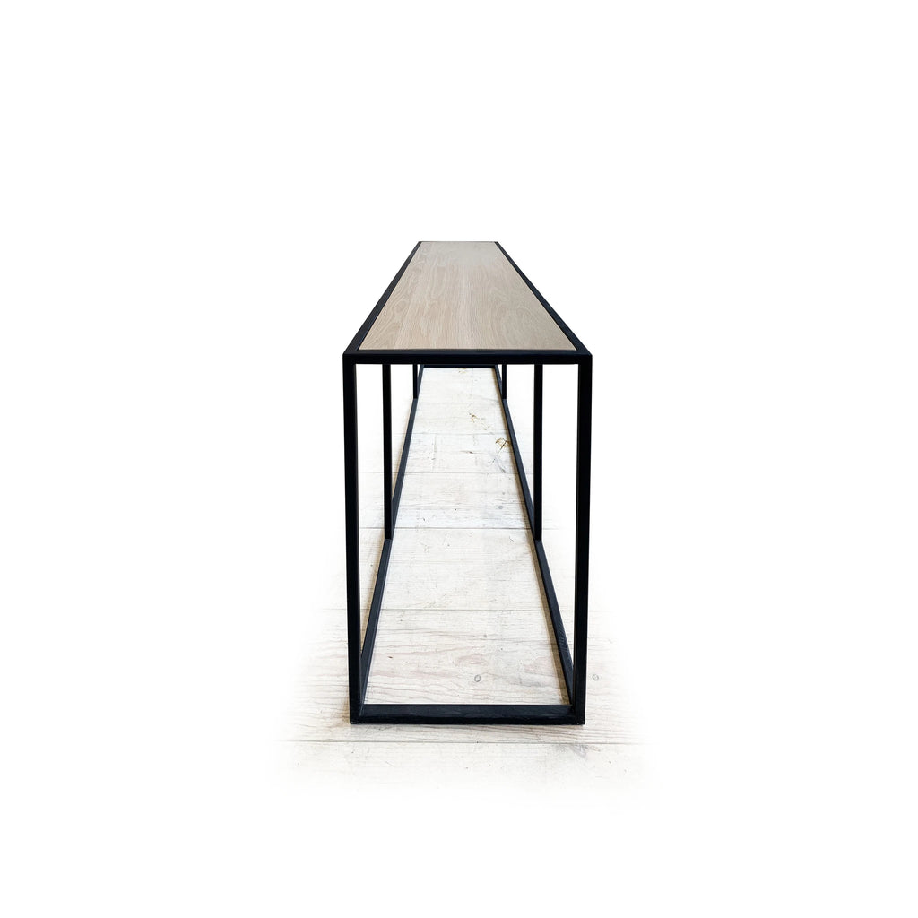 Weld Console, Muskoka Living Collection - Shown in black metal and natural finished oak.